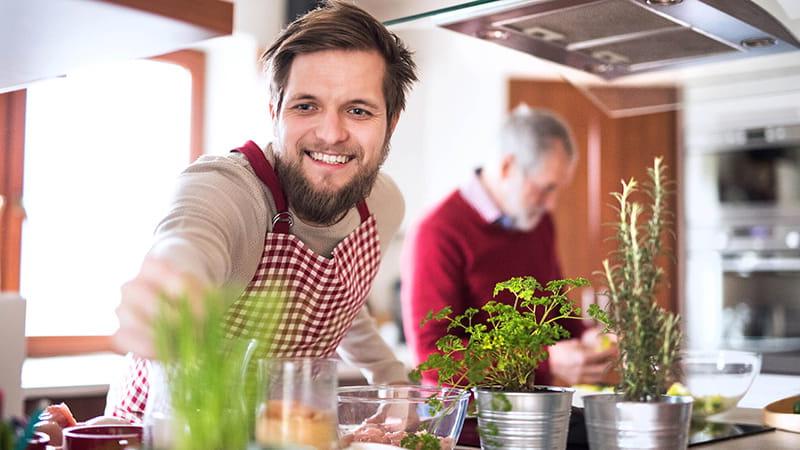 man cooking with his son